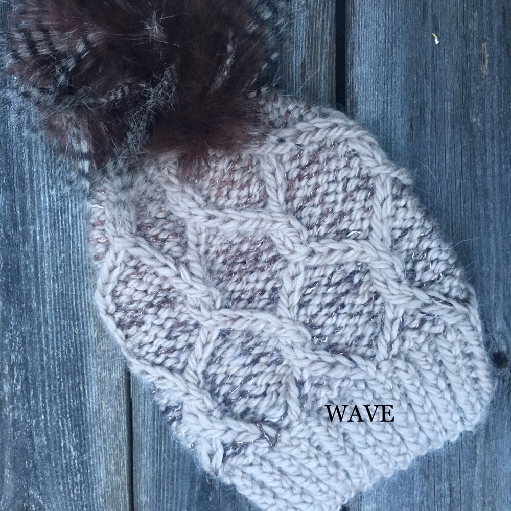 Cable knit beanie with faux fur pom